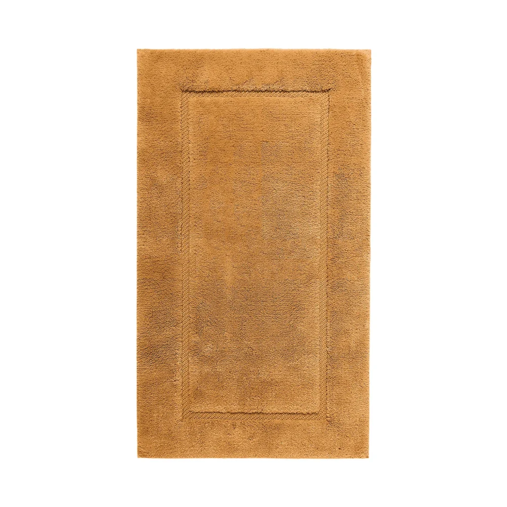 Högkvalitativt produktfoto sett ovanifrån på en Graccioza Egoist badrumsmatta i färgen Camel (Kamelbrun). Bilden fångar den tunga, högabsorberande luggen och den lyxiga finishen.
